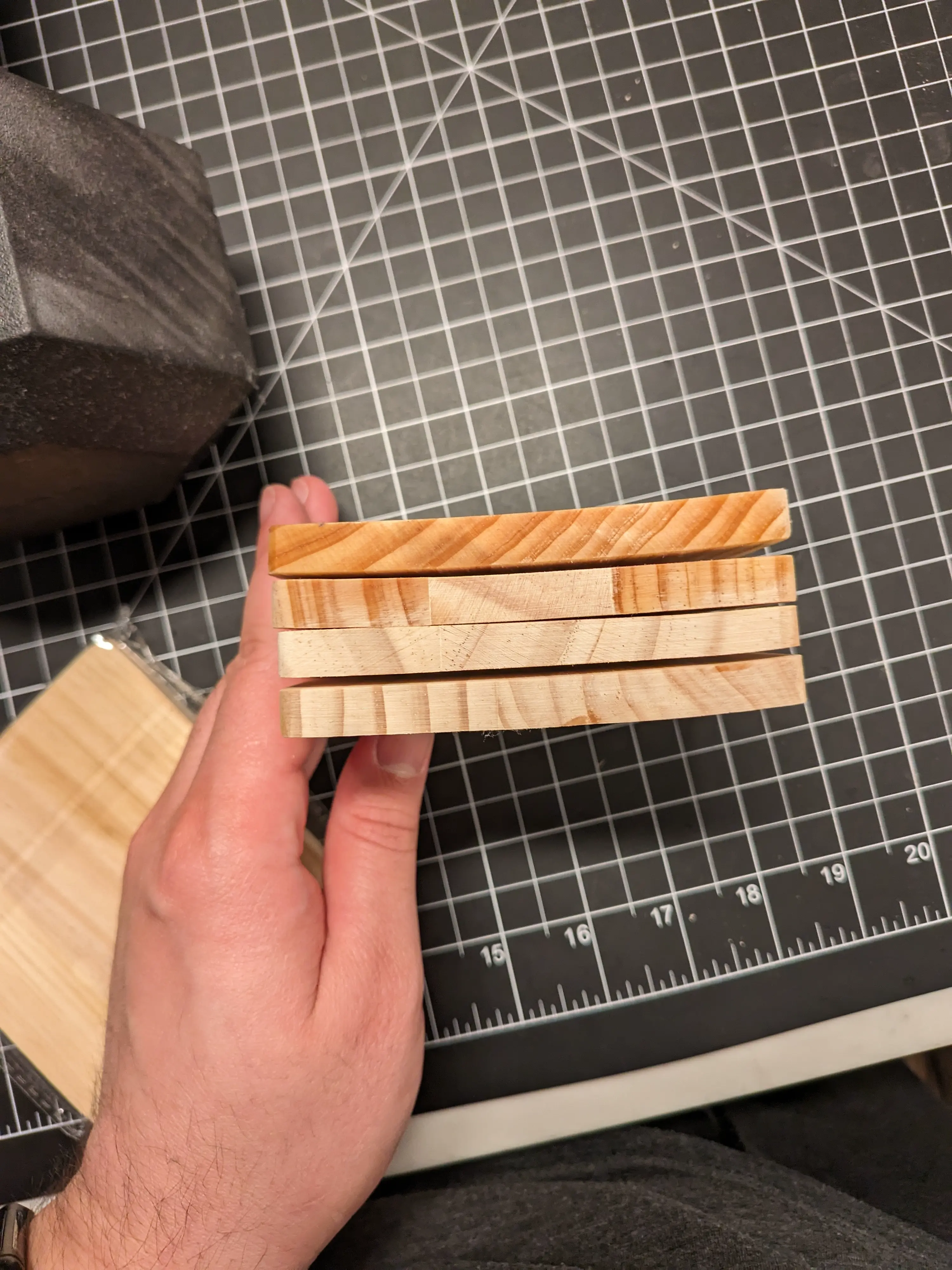 Image showing the coasters in profile. Rather than being flat, the coasters appear curved.